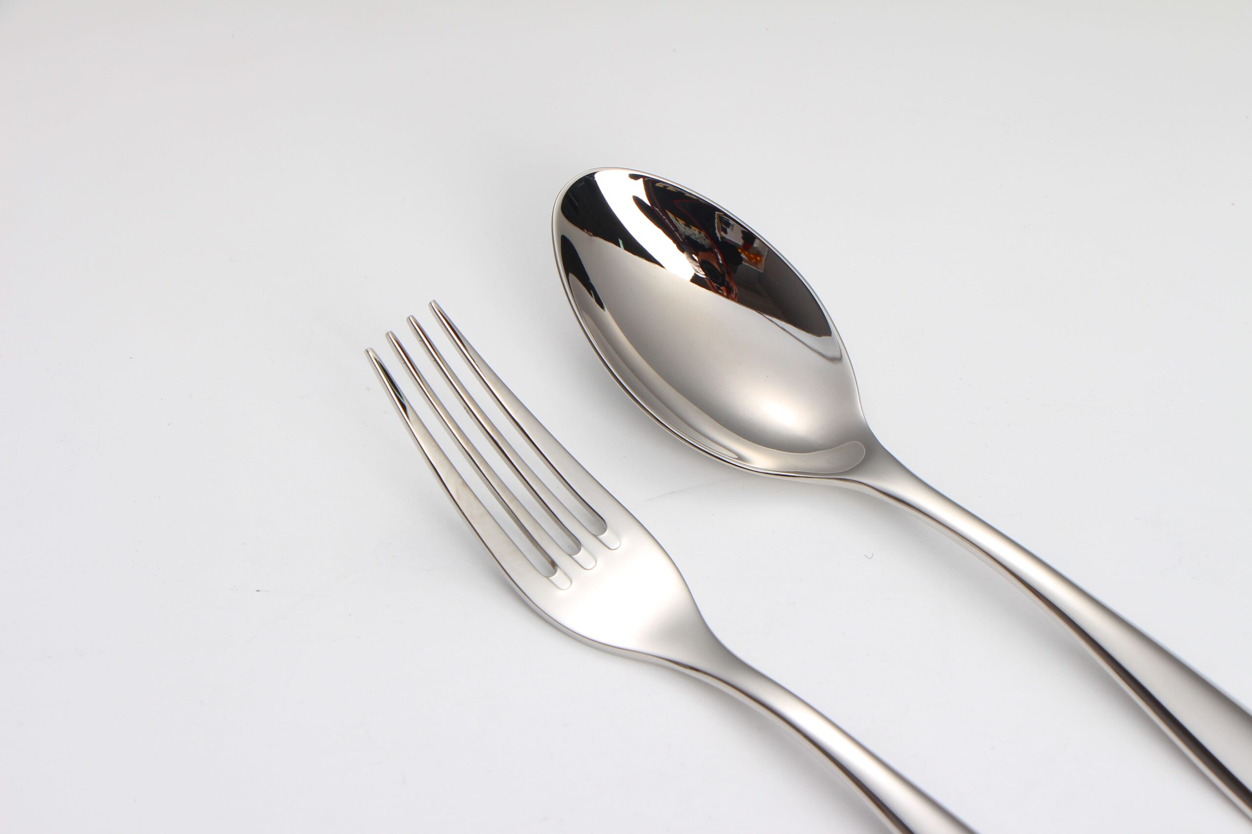 A close-up shot of the perfectly polished tines of a high-end fork.